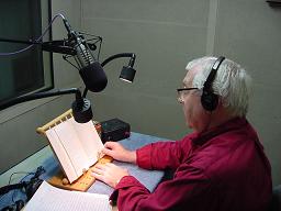 Photo of APH narrator reading a book